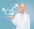 Smiling female doctor pointing to molecule