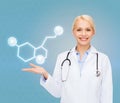 Smiling female doctor pointing to molecule