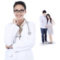 Smiling female doctor and pregnant couple Royalty Free Stock Photo