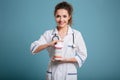 Smiling female doctor showing bottle of pills Royalty Free Stock Photo