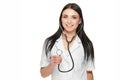 Smiling female doctor showing stethoscope at camera. Royalty Free Stock Photo