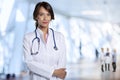 Confident female doctor with arms crossed standing in hospital Royalty Free Stock Photo