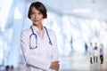 Confident female doctor with arms crossed standing in hospital Royalty Free Stock Photo