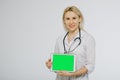 Smiling female doctor with stethoscope showing blank digital tablet pc. Royalty Free Stock Photo