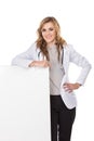 Smiling female doctor with stethoscope and white blank board, is Royalty Free Stock Photo