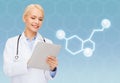 Smiling female doctor with tablet pc and molecule