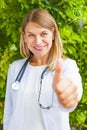 Smiling female doctor thumbs up Royalty Free Stock Photo