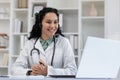 Friendly female doctor with headset during an online consultation Royalty Free Stock Photo