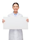 Smiling female doctor with white blank board Royalty Free Stock Photo