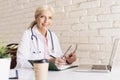 Smiling female doctor working at the doctor`s office Royalty Free Stock Photo
