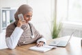 Smiling female doctor arranging appointment on phone Royalty Free Stock Photo