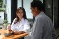 Female doctors giving advice to elderly patient in hospital.