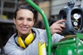 smiling female employee next to bottle with gas Royalty Free Stock Photo
