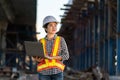Smiling female engineer holding laptop at expressway construction site Royalty Free Stock Photo