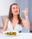 Smiling female is enjoying tasty green salad Royalty Free Stock Photo