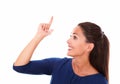 Smiling female with finger pointing up Royalty Free Stock Photo