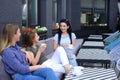 Smiling female friends laughing at cafe and gossiping, drinking coffee. Royalty Free Stock Photo