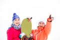 Smiling female friends with snowboard outdoors Royalty Free Stock Photo