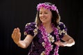 Smiling female Hawaiian girl dancing and singing with musical instruments like the ukulele Royalty Free Stock Photo