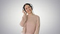 Smiling female with headphones walking and dancing to the music Royalty Free Stock Photo