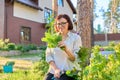 Smiling female holding set of popular culinary herbs arugula dill lettuce leaves Royalty Free Stock Photo