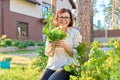 Smiling female holding set of popular culinary herbs arugula dill lettuce leaves Royalty Free Stock Photo