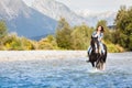 Smiling Female horse rider crossing river Royalty Free Stock Photo