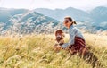 Smiling female hugs her beagle dog resting as they walking in mountains together Royalty Free Stock Photo