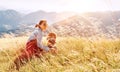 Smiling female hugs her beagle dog resting as they walking in mountains together Royalty Free Stock Photo