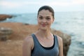 Smiling female jogger on the sea at sunset. Royalty Free Stock Photo