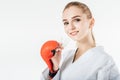 smiling female karate fighter holding mouthguard