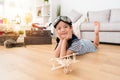 Smiling female kid aviator lying down on floor