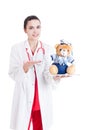 Smiling female medic presenting plush toy