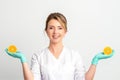 Smiling female nutritionist holding a sliced orange, looking at camera over white background, healthy diet concept. Royalty Free Stock Photo