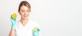 Smiling female nutritionist holding a sliced orange, looking at camera over white background, healthy diet concept. Royalty Free Stock Photo