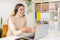 Smiling female operator working with telephone headset in call center Royalty Free Stock Photo