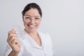 Smiling female orthodontist holds two transparent aligners. The dentist demonstrates the bite correction device Royalty Free Stock Photo