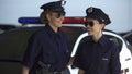Smiling female patrol officers walking to police station, successful operation Royalty Free Stock Photo