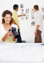 Smiling female photographer viewing images in camera. Portrait of smiling female photographer viewing images in camera