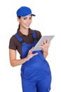 Smiling Female Plumber Working On Digital Tablet