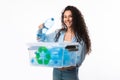 Female Putting Bottle To Box With Recycling Symbol, White Background
