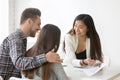 Smiling real estate agent talking to couple buying home together Royalty Free Stock Photo