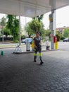 smiling female staff at gas station working outdoors