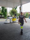 smiling female staff at gas station working outdoors