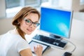 Smiling female student/ businesswoman using her tablet computer