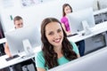 Smiling female student in computer class Royalty Free Stock Photo