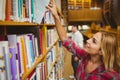 Smiling female student taking book Royalty Free Stock Photo