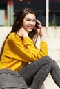 Smiling female student talking on mobile phone Royalty Free Stock Photo