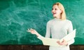 Smiling female teacher near chalkboard in school classroom. Teacher giving lesson to students in school or university Royalty Free Stock Photo