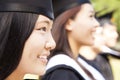 smiling female university graduate with classmates Royalty Free Stock Photo